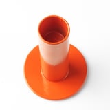 Bright orange steel candle holder with wide base, smooth edges, and hollow interior. Part of ikeas nytillverkad collection.