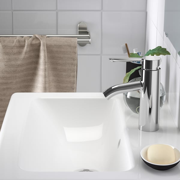 A sleek, modern sink with a shiny chrome faucet, featuring a deep bowl to prevent splashes, and a soap dish nearby.