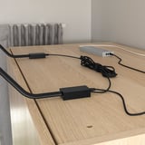 Wooden surface with two black rectangular led lights and connected wires.