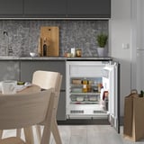 Kitchen with compact fridge open, led lit shelves.