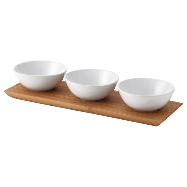Three white bowls on a light brown bamboo tray; minimalist design, perfect for snacks or dips.