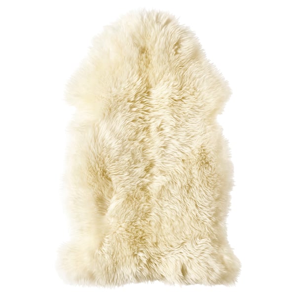 A soft, white, fluffy sheepskin rug, perfect for floors or furniture, offering warmth and comfort.