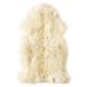 A soft, white, fluffy sheepskin rug, perfect for floors or furniture, offering warmth and comfort.