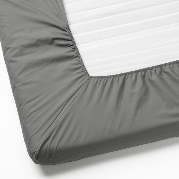 A fitted sheet with gray elastic corners tightly covering a white mattress, showcasing its fitted design and material quality.