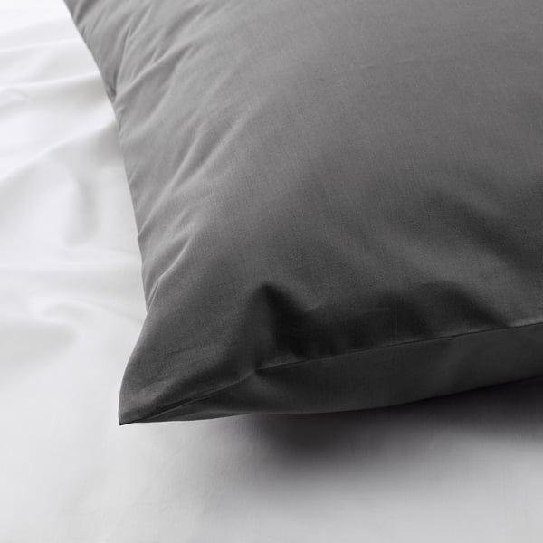 Close-up of smooth, high-quality pillowcase in dense fabric, crisp and cool, showcasing fine craftsmanship.