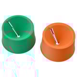 Two colored cylindrical kitchen tools side-by-side; green and orange, each with a horizontal blade slot.