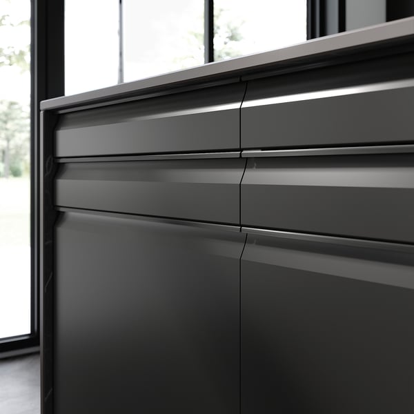 Black modern kitchen cabinet with sleek, matte finish and integrated handles.