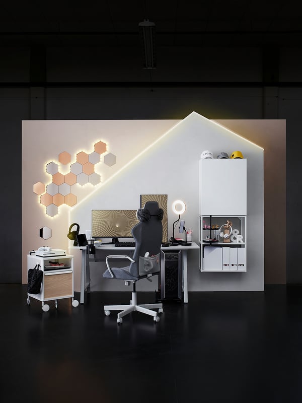 Modern gaming setup with UTESPELARE chair & desk. White, hexagonal lighting, monitor, accessories.