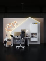 Modern gaming setup with UTESPELARE chair & desk. White, hexagonal lighting, monitor, accessories.