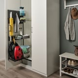 Organized cleaning supplies on pull-out shelf in cabinet.