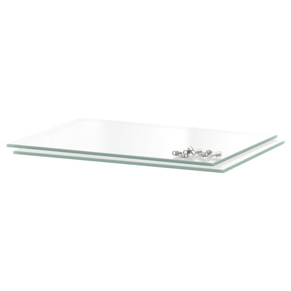 Clear rectangular glass shelf, part of UTRUSTA series, showcased with small metallic items, simple design, modern look.