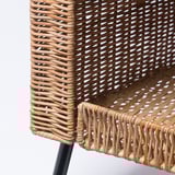 Woven rattan cat house, beautifully crafted with natural, sturdy material and dark legs, offering cozy comfort for pets.