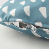 A close-up of a blue and white patterned dog cushions zipper, showcasing its durable and high-quality fabric.