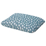 An aqua blue pet cushion with white teardrop patterns. Its square-shaped with a patterned fabric cover.