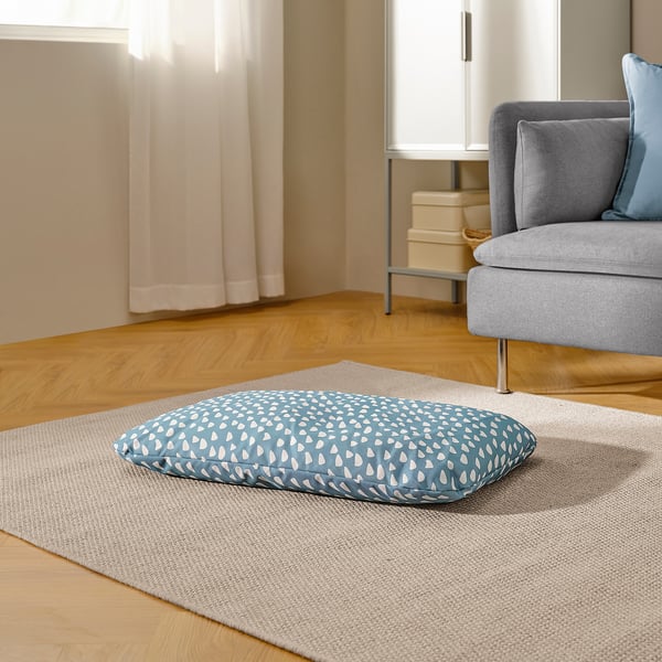 Cushion on rug for pet comfort, with gentle patterns and cozy design.