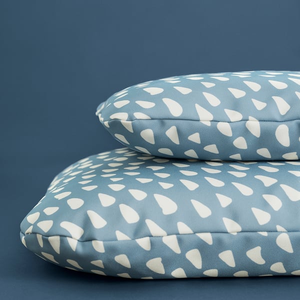 Two blue and white patterned cushions stacked, ideal for pet comfort.