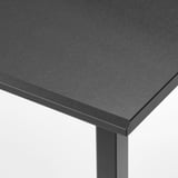 Close-up of sleek black desk edge, smooth surface, sturdy frame.