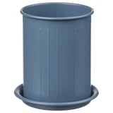 Blue cylindrical VÄLVÅRDAD container with vertical ribs on a matching saucer. Made of powder-coated galvanized steel and stainless steel.