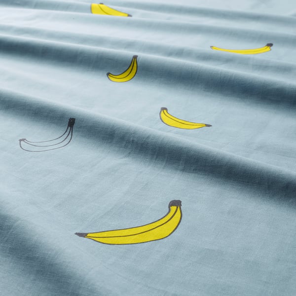 Banana print on light blue fabric. Whimsical, durable.