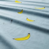 Banana print on light blue fabric. Whimsical, durable.