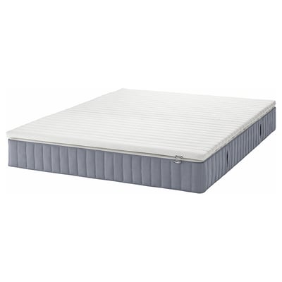 The VALEVÅG pocket spring mattress in white and gray, rectangular, with a padded design suitable for side sleepers.
