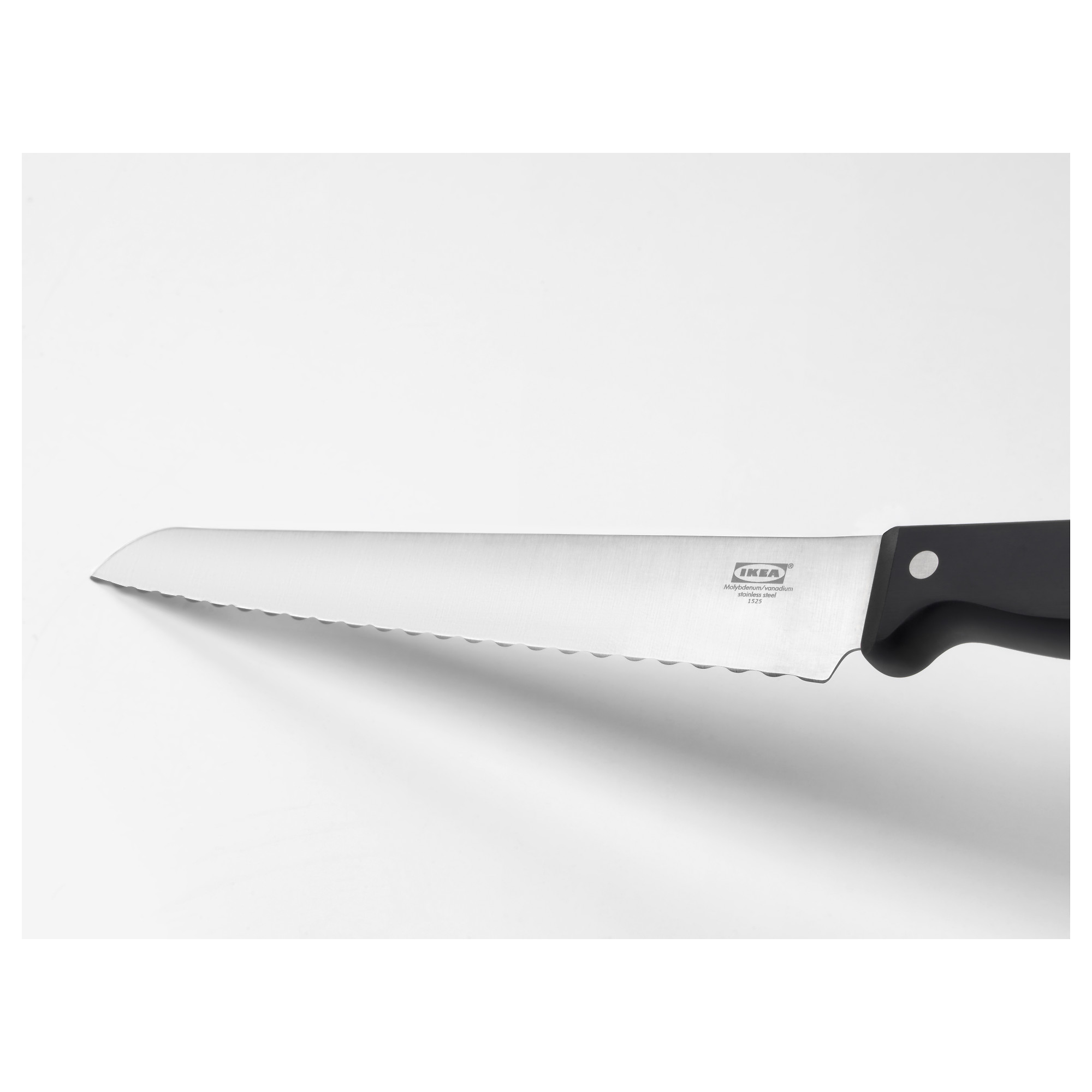 Serrated kitchen knife with black handle; stainless steel blade; designed for cutting bread and soft vegetables.