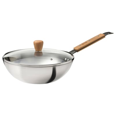 A VARDAGEN wok with a wooden handle and a glass lid. The wok is silver with a round design and a flat bottom.