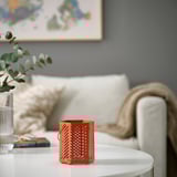 Living room with white couch, gray walls, red lantern on table with plant and books.