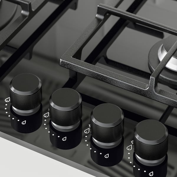 Black gas stove with four knobs, cast iron supports, glass surface. Advanced safety and control for precise cooking.