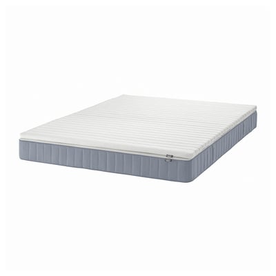 A white VESTERÖY pocket spring mattress with a blue edge, designed for medium-weight sleepers. Its rectangular and a breathable fabric for comfort.