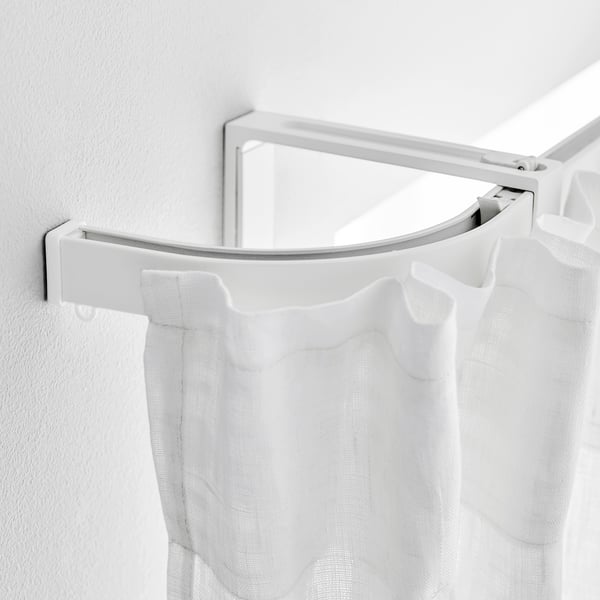 White curved curtain rod with sheer white curtains hanging, showing flexible design and easy assembly.