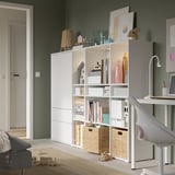 Green living room with bookshelf and toys.