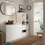 Modern entryway setup with white VIHALS storage units, mirror, decorative items, and wooden accents.