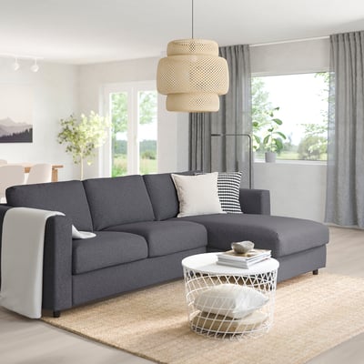 Modern living room with gray VIMLE sectional sofa, white coffee table, and large window.