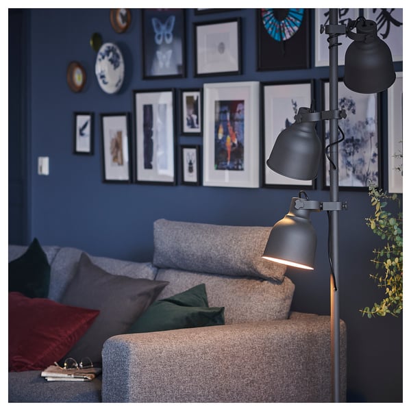 Cozy living room with navy blue wall, grey VIMLE sofa, dark lamp, colorful pillows, and wall art.