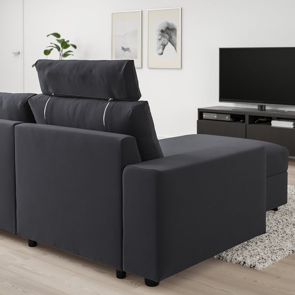 Dark gray VIMLE sectional sofa with chaise, adjustable headrest, and storage. Positioned in a cozy living room with tv and decor.