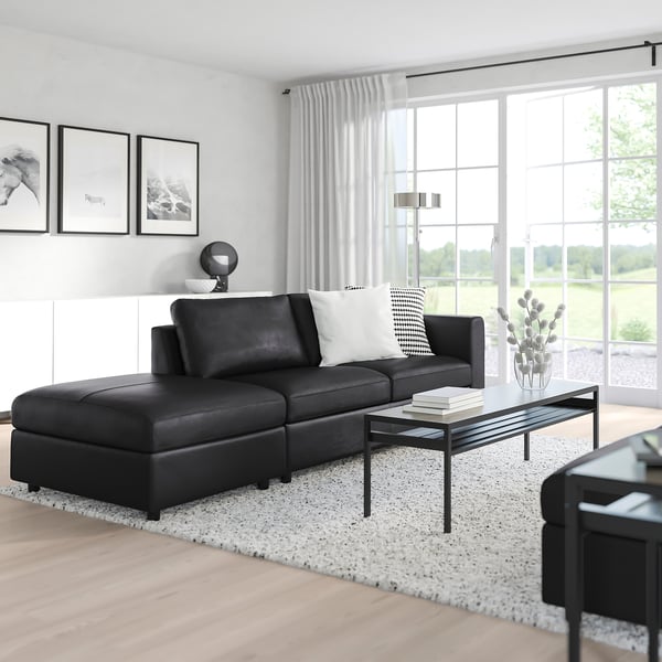 Modern living room with VIMLE sofa, large windows, and nature prints.