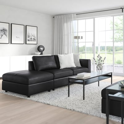 Modern living room with VIMLE sofa, large windows, and nature prints.
