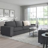 Contemporary living room with VIMLE sofa, curtains, and large windows. Sofa is spacious with dark gray cushions.