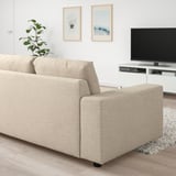 Modern living room with light beige VIMLE sofa, matching decor, and tv on white stand.