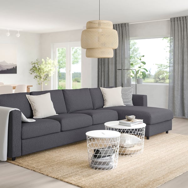Modern living room with VIMLE sectional, white tables, rug, plants, and large windows with curtains.