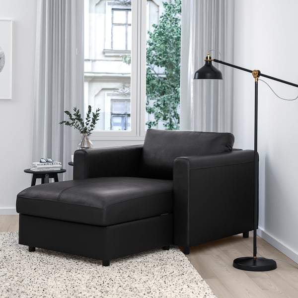 Modern living room: black VIMLE sofa. Compact, comfortable, with storage & large window.