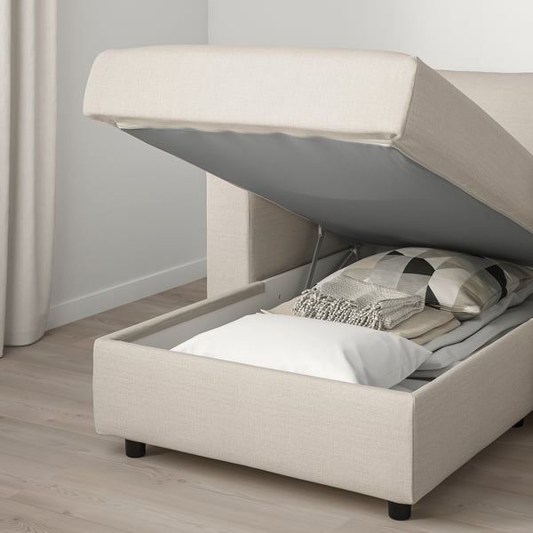 A cream-colored VIMLE sofa with storage. The chaise longue has an open lid revealing pillows inside.