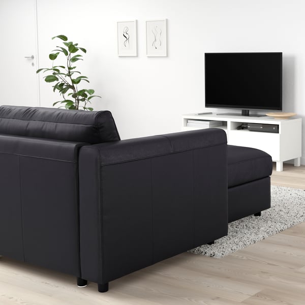 Black VIMLE sofa with chaise, minimalist living room, tv, plant, art.