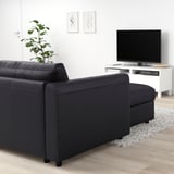 Black VIMLE sofa with chaise, minimalist living room, tv, plant, art.