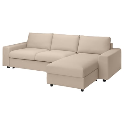 A beige VIMLE sectional sofa-bed with a chaise, featuring a modern design with clean lines and plush cushions, supported by dark wooden legs.