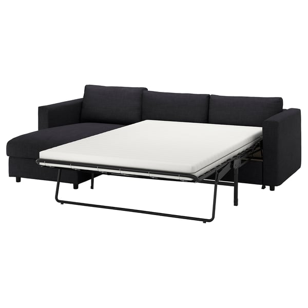 Dark gray VIMLE sofa bed, modern design, with white mattress.