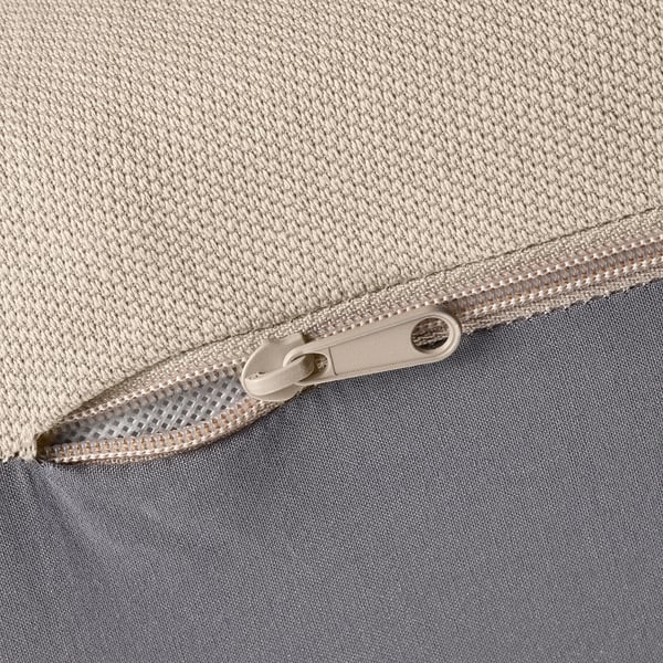 Close-up of zipper on durable, textured fabric bag. Zipper pulled halfway, showing smooth, quality material.