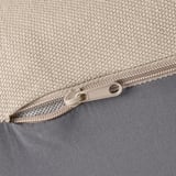 Close-up of zipper on durable, textured fabric bag. Zipper pulled halfway, showing smooth, quality material.