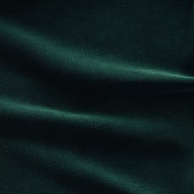 Lush green velvet close-up, soft pile, subtle reflective shine.
